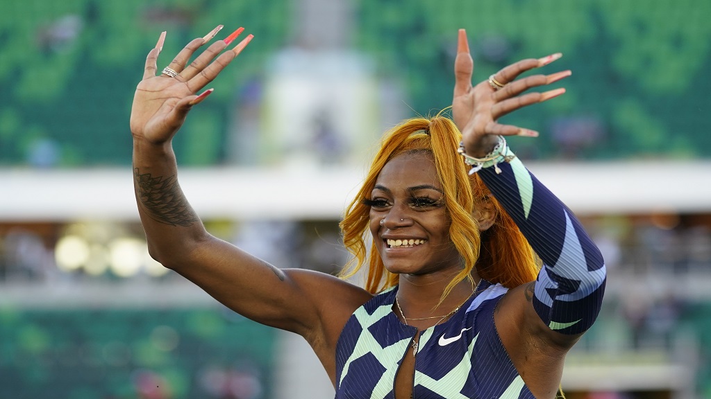Sha’Carri Richardson waves after winning the women’s 100-meter run at the U.S. Olympic Track and Field Trials Saturday, June 19, 2021, in Eugene, Ore. (AP Photo/Ashley Landis)