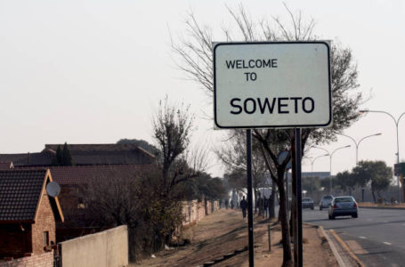 A roadside welcome banner inviting you to visit the Soweto area of Johannesburg. Road sign, road sign “Welcome to SOWETO” at the entrance to the suburb of Johanessburg – Soweto, South Africa.
