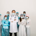 team-doctors-nurses-wearing-disposable-protection-suits-face-masks-fighting-covid19-scaled-1.jpg